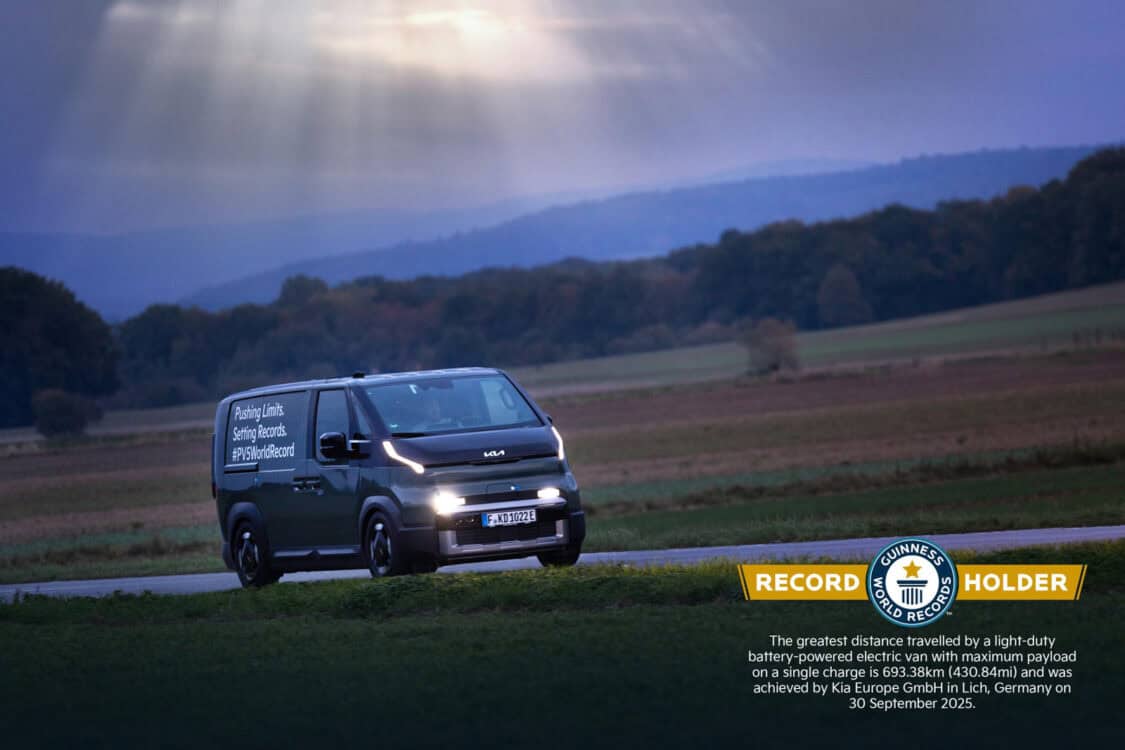 Kia PV5 Cargo electric van driving at dawn during Guinness World Record 693 km run in Germany.
