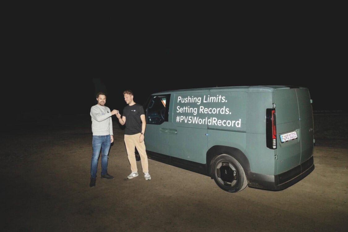 Drivers celebrate beside the Kia PV5 Cargo electric van after completing the Guinness World Record run.