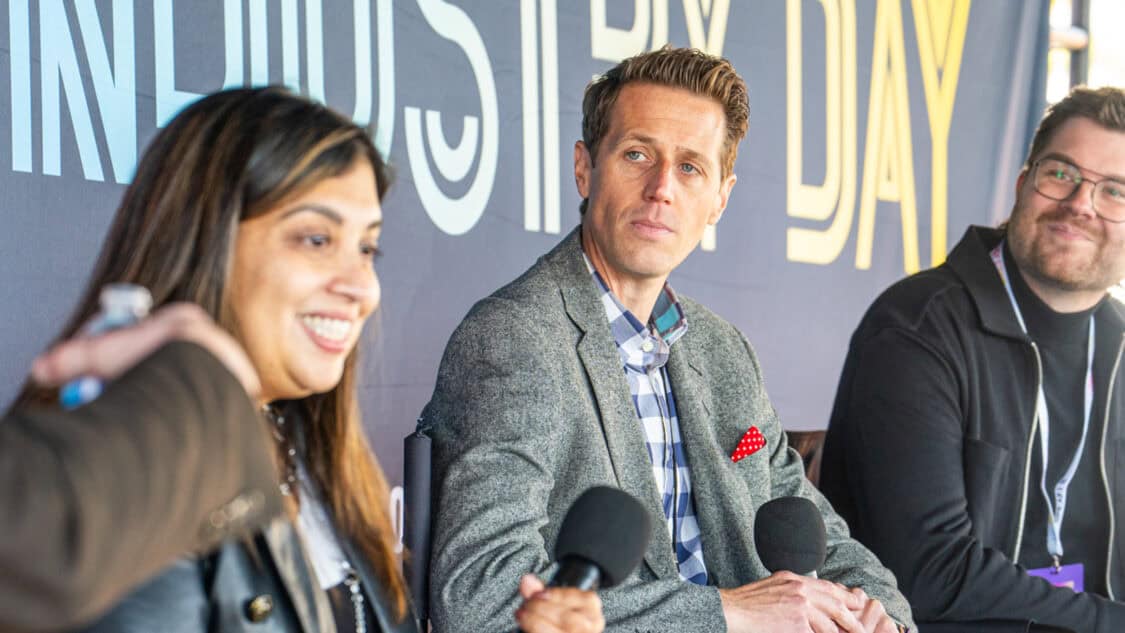 Sharda Mohammed of Michelin, Matthew Chandler of QNX, and Marc-Olivier Drouin of Can-Am discuss EV performance onstage at Electrify Expo Industry Day in New York.