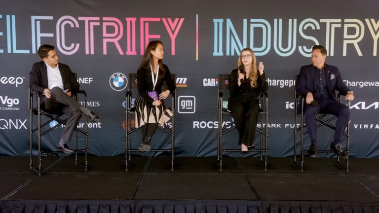 Panelists at Electrify Expo Industry Day discuss EV pricing and the real cost of ownership during a live session on stage.