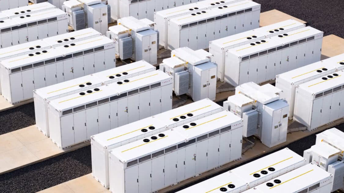 Rows of utility-scale battery energy storage units at a grid storage facility. (Render by Tesla)