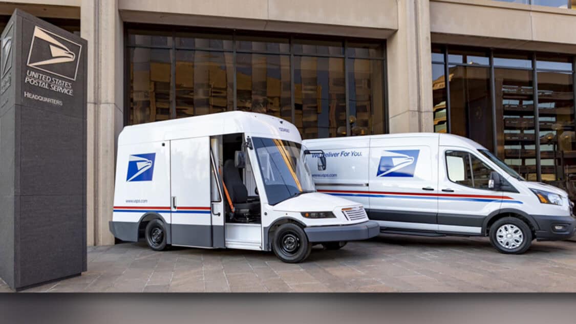 USPS electric delivery trucks displayed at headquarters, highlighting the agency’s growing zero emission fleet.