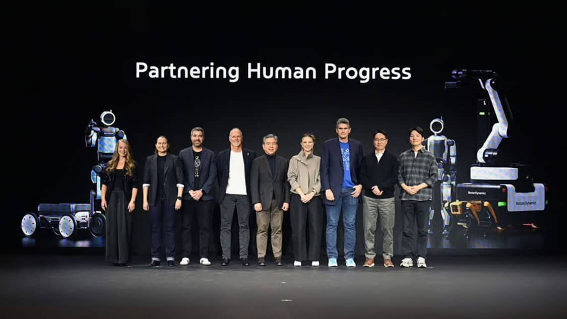Hyundai and Boston Dynamics executives on stage at CES 2026 with Atlas robot and industrial robotics platforms.