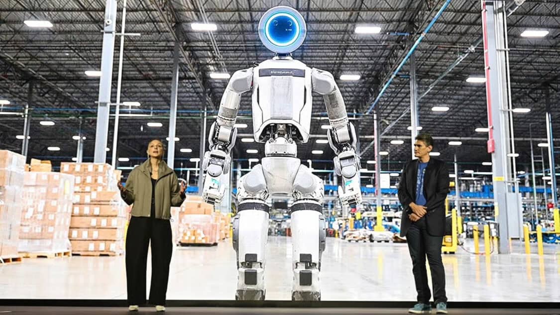 Atlas robot prototype inside a Hyundai factory environment at CES 2026, illustrating human supervised industrial robotics in real production spaces.