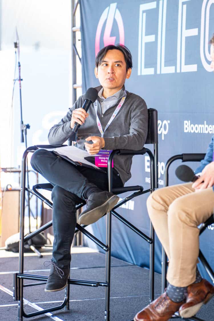 Panel discussion on autonomy, AI safety, and robotic EV charging at Electrify Expo Industry Day. Moderator: Siong-Hu Wong, BloombergNEF; Speakers: Clayton Tino, President and Chief Operating Officer of Beep; Mark Henderson, Chief Commercial Officer of Rocsys.